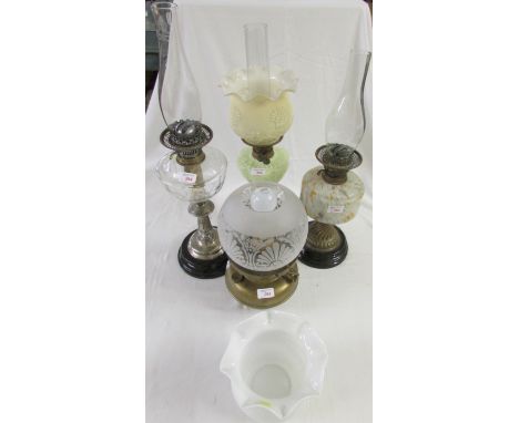 Four oil lamps (including one converted to electricity - needs rewire) - (1) a brass lamp with a mottled glass reservoir; (2)
