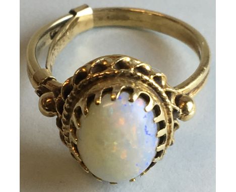 Yellow metal opal ring, the opal 10mm x 7mm in a claw setting, indistinct stamped mark to the shank perhaps 14K, gross weight