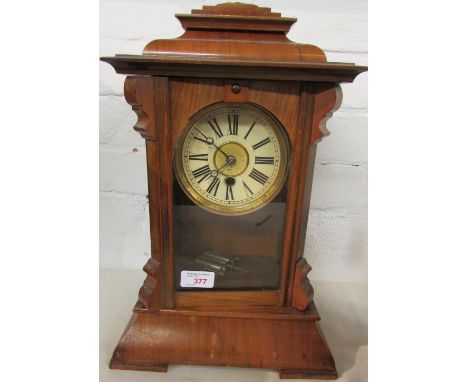 H.A.C. walnut cased mantel clock, enamel dial with gilt brass centre, crossed arrows device, Roman chapter, the back labelled