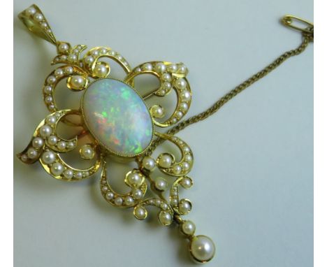 15 carat gold scroll pendant brooch set with an opal and eighty-two seed pearls of graduated sizes, the opal approximately 17