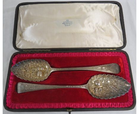A matched pair of Georgian silver berry spoons in a more recent fitted case, the first bearing marks for London, 1821, and pa