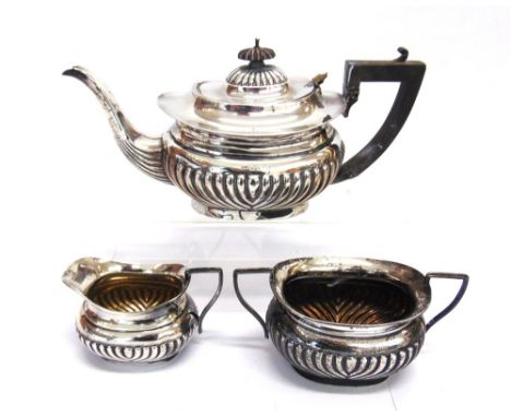 A MATCHED THREE PEICE SILVER TEA SERVICE maker W.A., Birmingham 1912-13, of rounded rectangular gadrooned form, 963g (31 troy