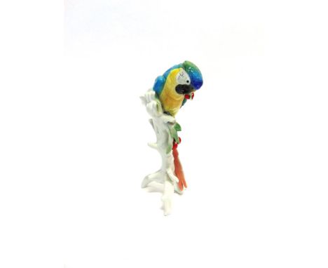 A LARGE KARL ENS FIGURE OF A PARROT  resting on a tree trunk with cherries, green 'Ens' script mark to base and impressed '76