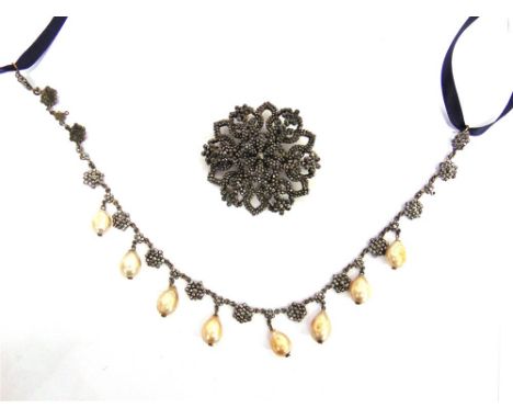 AN EARLY VICTORIAN CUT STEEL NECKLACE with simulated pearl drops, 31cm long, with ribbon tie; and a cut steel brooch of simil