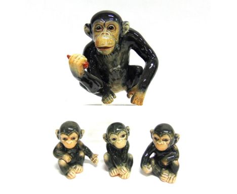 A SYLVAC FIGURE OF A CHIMPANZEE  17.5cm high, and a set of three Goebel chimps impressed '541', '542' and '543' (4)