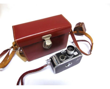 A BOLEX B8 CINE CAMERA with a Switar 1:1,5 f=12.5mm lens, complete with instruction manual, in brown leather travel case