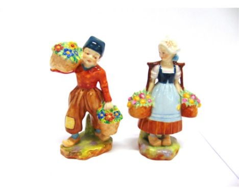 A PAIR OF ROYAL WORCESTER FIGURES  of a young Dutch girl and boy, each carrying baskets of flowers, puce printed marks to bas