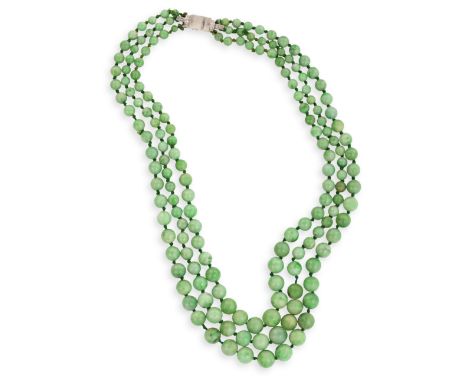 AN ART DECO JADEITE JADE BEAD NECKLACE WITH DIAMOND AND ROCK CRYSTAL CLASPThe triple strands of graduated green jadeite jade 