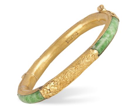 A JADEITE JADE AND GOLD BANGLEThe green jadeite jade accented by gold panels of floral and foliate decorations between furthe