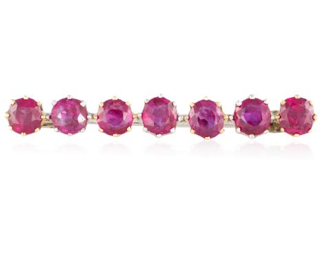 A RUBY BAR BROOCHDesigned as a line of oval and cushion-shaped rubies, each within multiple-claw setting, mounted in gold, ca