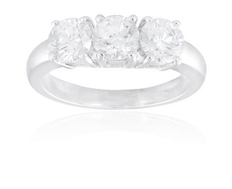 A THREE-STONE DIAMOND RINGSet with a row of three round brilliant-cut diamonds within four-claw settings, weighing approximat