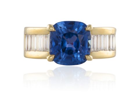 A FINE SAPPHIRE AND DIAMOND RINGThe cushion-shaped sapphire weighing 6.26cts within a four-claw setting, between baguette-cut