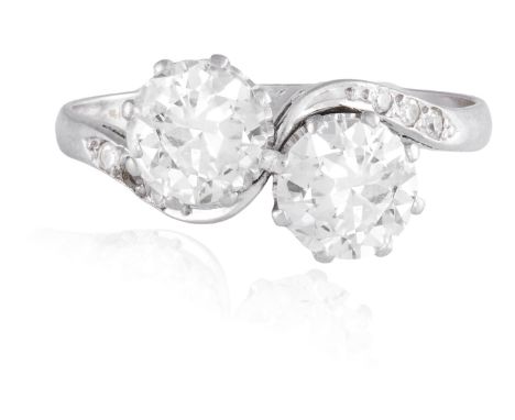 A DIAMOND CROSS-OVER RINGThe two European-cut diamonds between single-cut diamond shoulders, mounted in platinum, two princip