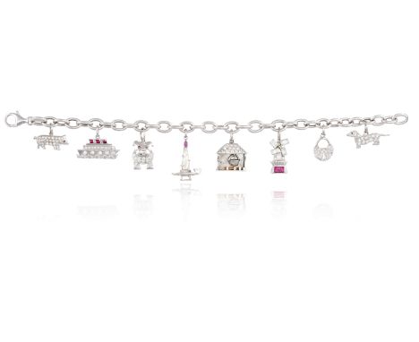 A DIAMOND AND RUBY CHARM BRACELETThe gold cable-link chain suspending eight diamond and ruby-set charms including a dachshund