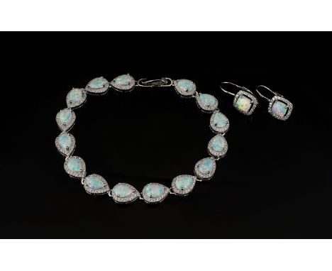 Opal and Zirconia Tennis Bracelet and Pair of Drop Earrings, the bracelet comprising fifteen pear cut Opals, set in a row, ea