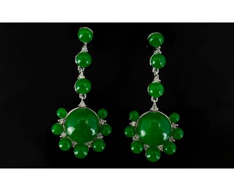 Green Jade Long Drop Earrings, 20cts; each earring comprising a large round cut jade cabochon with small, similar cabochons t