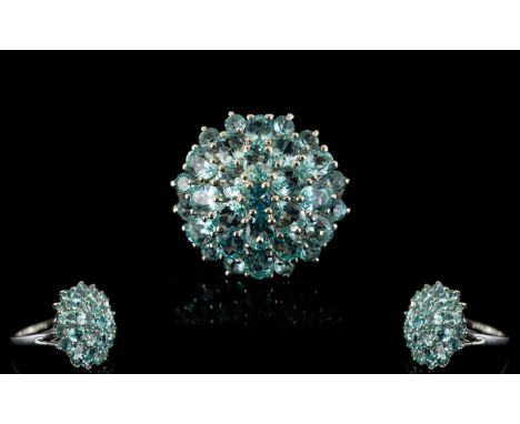 Paraibe Apatite Round Cluster Ring, a domed cluster of 4.25cts of round and oval cut paraibe apatites, a natural clear sea bl