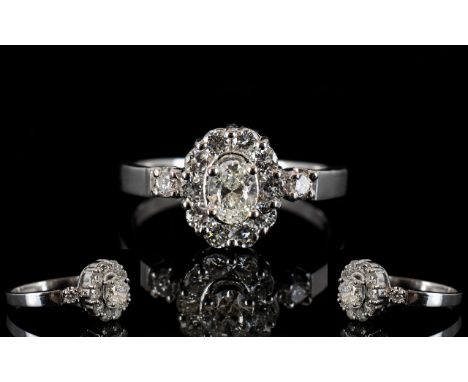 18ct Gold Diamond Set Cluster Ring Set with central oval cut diamond, surrounded by round brilliant cut diamonds and diamond 