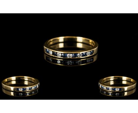 9ct Gold Sapphire And Diamond Eternity Ring Set with alternating round cut sapphires and diamonds, fully hallmarked, ring siz