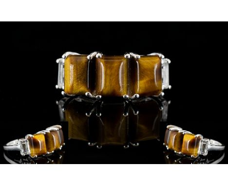 Tiger's Eye Three Stone Band Ring, accented with white topaz; the three rectangular cabochon cut tiger eye stones, totalling 