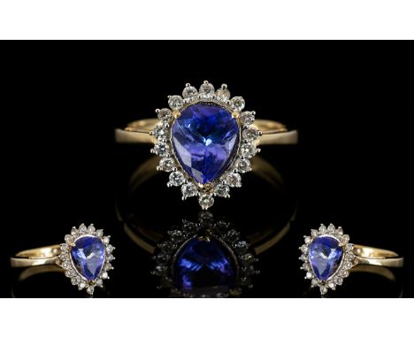 9ct Gold Sapphire And Diamond Dress Ring Pear shaped central sapphire surrounded by round cut diamonds, fully hallmarked, rin