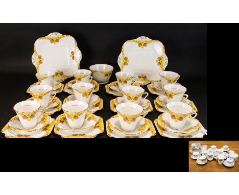 Early 20th Century Grafton China Part Tea Service Of art deco form comprising twelve trio's, two cake plates, cream jug, and 