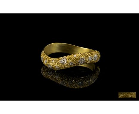 Contemporary Designed 18ct Golf Snake Style Coiled Hinged Bangle set with diamonds and yellow sapphires. Marked 750-18ct, hal