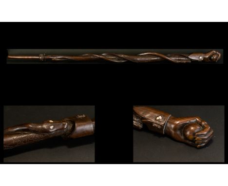 Indonesian Hardwood Carved Walking Stick The top carved in the form of a clenched hand, the body carved with snake with abalo