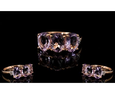 Rose de France Amethyst Trilogy Ring, with diamond accents; three oval cut Rose de France amethysts of similar size, totallin