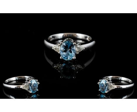 Platinum Aquamarine And Diamond Set Ring Central oval cut aquamarine set between to triangular cut diamonds, fully hallmarked