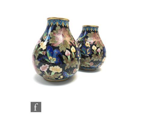 A pair of Chinese Cloisonne vases, each of pear form with ruyi upper borders, the gilt wire filled with polychrome enamel dep
