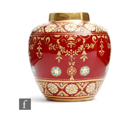 A small early 20th Century Coalport vase of ovoid form with a squat collar neck, the dark red ground with a gilt overlay patt