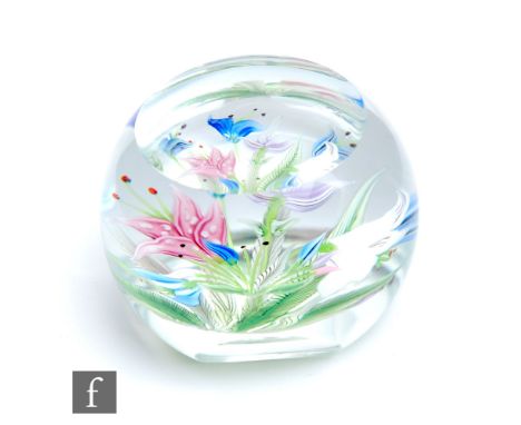 A Caithness faceted glass paperweight titled Oriental Garden and designed by Allan Scott, internally decorated with a lamp wo