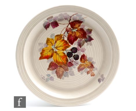 A later Clarice Cliff shallow ribbed wall plaque circa&nbsp; 1938, hand painted in the Bramble pattern with a fruiting autumn