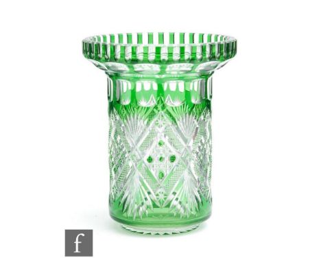 A 20th Century crystal glass vase of footed cylindrical form with a collar rim, cased in emerald green over clear crystal and