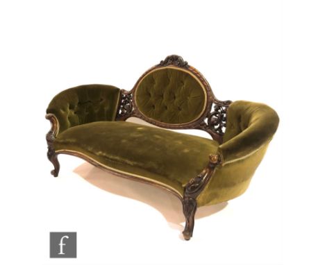 A Victorian serpentine-fronted sofa with exposed walnut frame, carved with foliate scroll detail over cabriole front legs, up