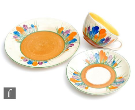 A Clarice Cliff Globe shape tea cup, saucer and side plate circa 1929, hand painted in the Crocus pattern with crocus sprays 