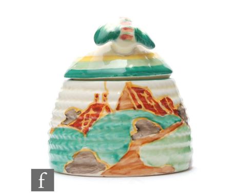 A small size Clarice Cliff Beehive honey pot circa 1933, hand painted in the Secrets pattern with a tree and cottage coastal 
