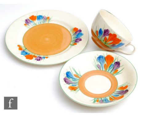 A Clarice Cliff Globe shape tea cup, saucer and side plate circa 1929, hand painted in the Crocus pattern with crocus sprays 