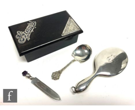 A hallmarked silver backed small hand mirror with a silver bookmark, a caddy spoon and an ebonised silver mounted stamp box, 