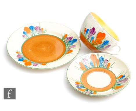 A Clarice Cliff Globe shape tea cup, saucer and side plate circa 1929, hand painted in the Crocus pattern with crocus sprays 