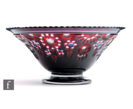 An early 20th Century crystal glass bowl of footed and flared form, double cased with blue to the exterior and ruby to the in