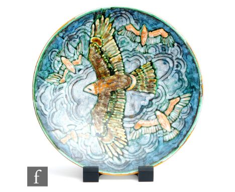 A later 20th Century Poole Pottery studio charger designed by Tony Morris and decorated with an eagle in flight with four sma