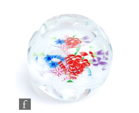 A Caithness faceted glass paperweight designed by Harry McKay, with a lamp work bouquet over an upset muslin ground, engraved