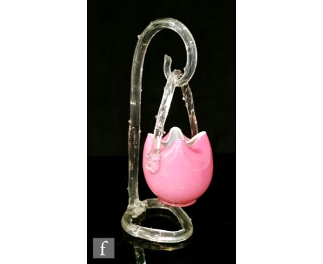 A late 19th Century small posy basket decorated in pink over opal with applied clear loop handle, suspended from a clear rust