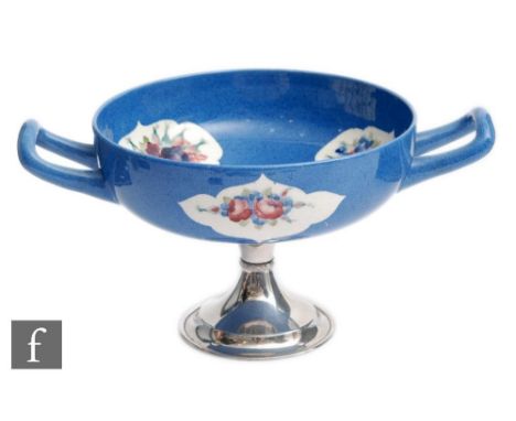 A William Moorcroft twin handled pedestal comport decorated in the Forget-me-not panel pattern, green signature beneath silve