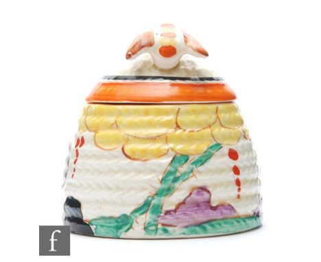 A small size Clarice Cliff Beehive honey pot circa 1932, hand painted in the Summerhouse pattern with a stylised Pagoda and t