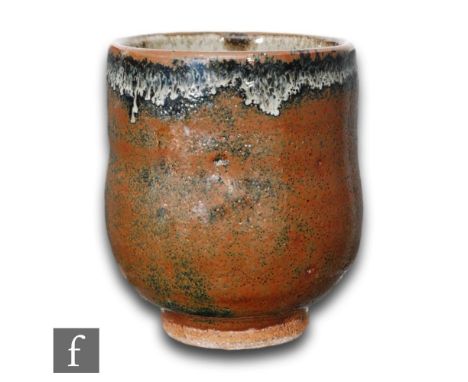 A small hand thrown Yunomi beaker of footed circular form, from The Leach Pottery, by William (Bill) Marshall, tenmoku glaze 