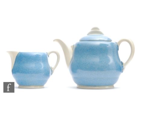 A Clarice Cliff Windsor shape teapot and matched milk jug circa 1936, hand enamelled with a tonal blue stippled ground and ho