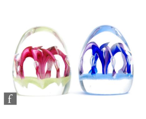 Two Paul Ysart paperweight internally decorated with a stylised lamp work flower with controlled air bubble details, the firs